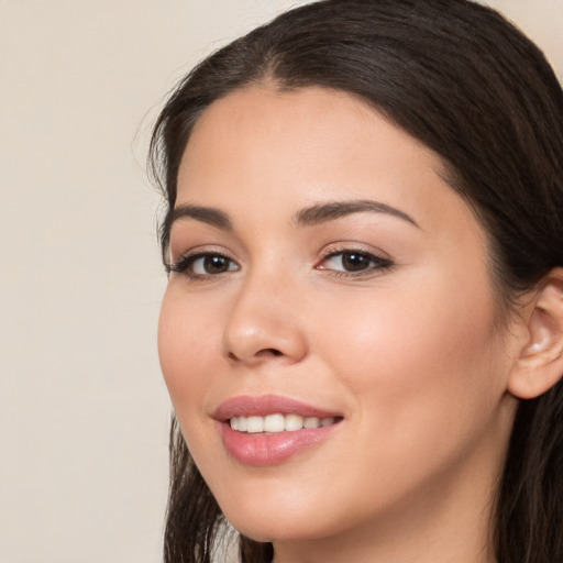 Joyful white young-adult female with long  brown hair and brown eyes