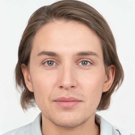 Joyful white young-adult male with medium  brown hair and grey eyes