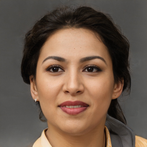 Joyful latino young-adult female with long  brown hair and brown eyes