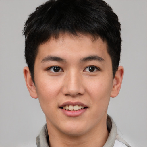 Joyful asian young-adult male with short  brown hair and brown eyes