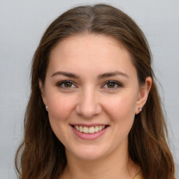 Joyful white young-adult female with long  brown hair and green eyes