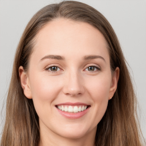 Joyful white young-adult female with long  brown hair and grey eyes