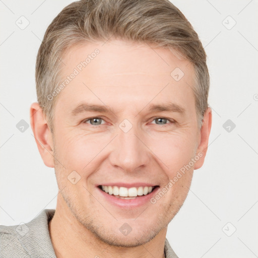 Joyful white adult male with short  brown hair and grey eyes