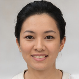 Joyful asian young-adult female with short  black hair and brown eyes