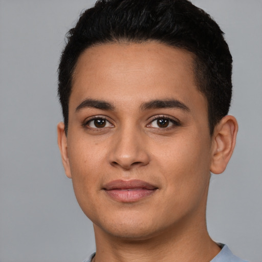 Joyful latino young-adult male with short  black hair and brown eyes