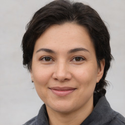 Joyful white adult female with medium  brown hair and brown eyes