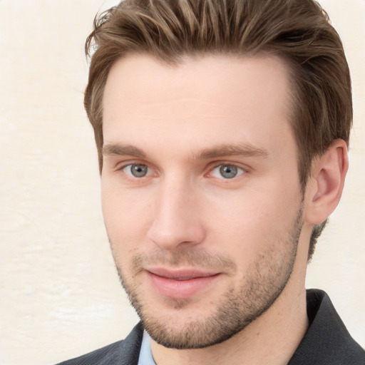 Joyful white young-adult male with short  brown hair and grey eyes