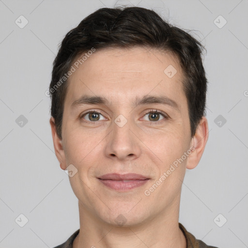 Joyful white adult male with short  brown hair and brown eyes