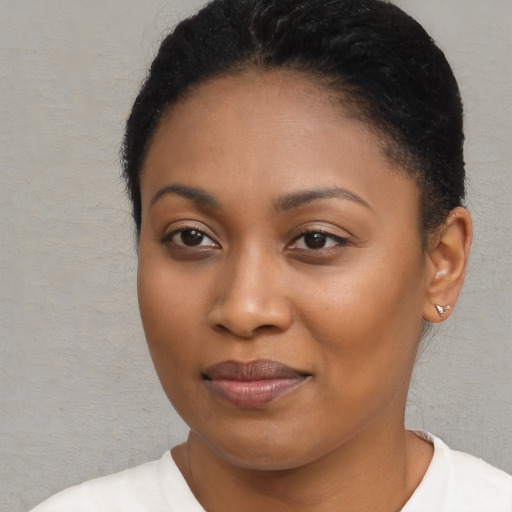 Joyful black young-adult female with short  brown hair and brown eyes