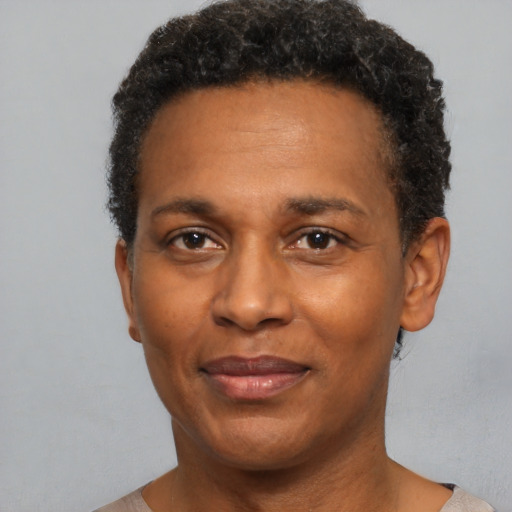 Joyful black adult male with short  brown hair and brown eyes