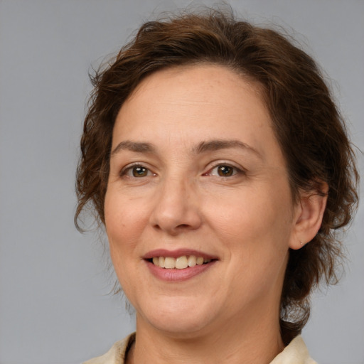 Joyful white adult female with medium  brown hair and brown eyes