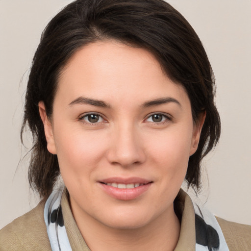 Joyful white young-adult female with medium  brown hair and brown eyes