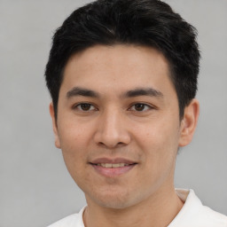 Joyful asian young-adult male with short  black hair and brown eyes