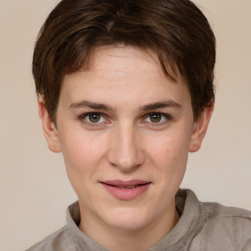 Joyful white young-adult female with short  brown hair and grey eyes