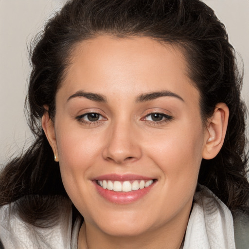 Joyful white young-adult female with long  brown hair and brown eyes