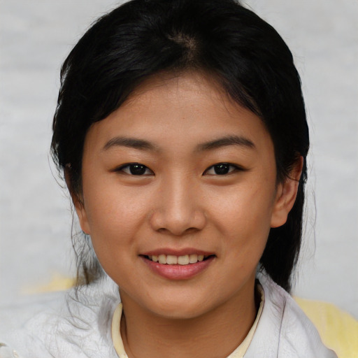 Joyful asian young-adult female with short  black hair and brown eyes