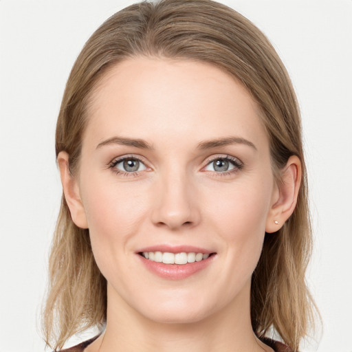 Joyful white young-adult female with long  brown hair and blue eyes