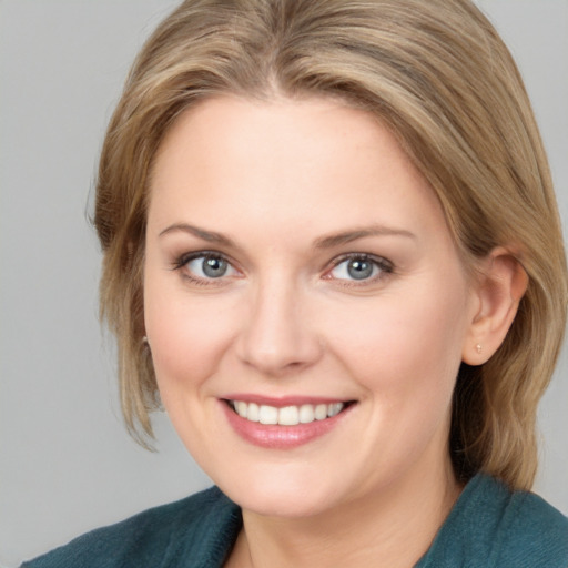 Joyful white young-adult female with medium  brown hair and blue eyes