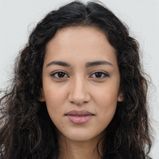 Joyful latino young-adult female with long  brown hair and brown eyes