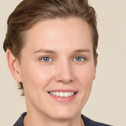 Joyful white young-adult female with short  brown hair and grey eyes