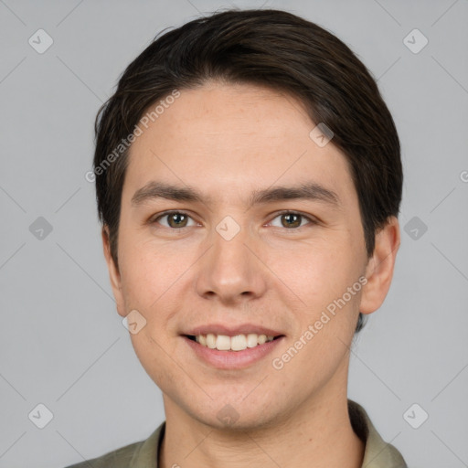 Joyful white young-adult male with short  brown hair and grey eyes