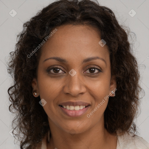 Joyful black young-adult female with long  brown hair and brown eyes