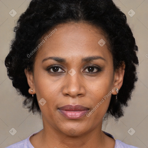 Joyful black adult female with short  brown hair and brown eyes