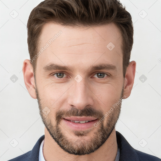 Joyful white young-adult male with short  brown hair and grey eyes