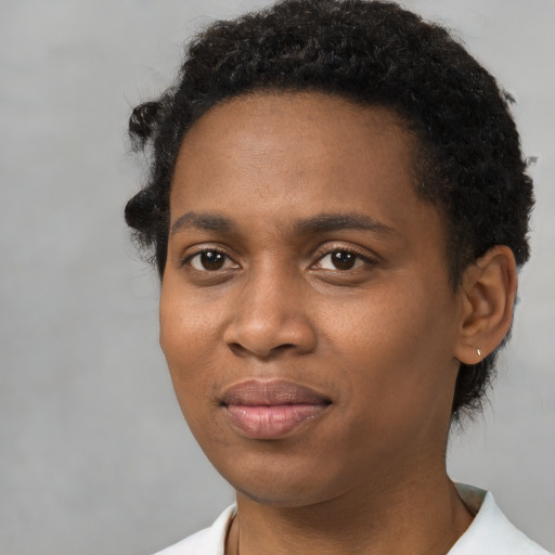 Joyful black young-adult male with short  brown hair and brown eyes
