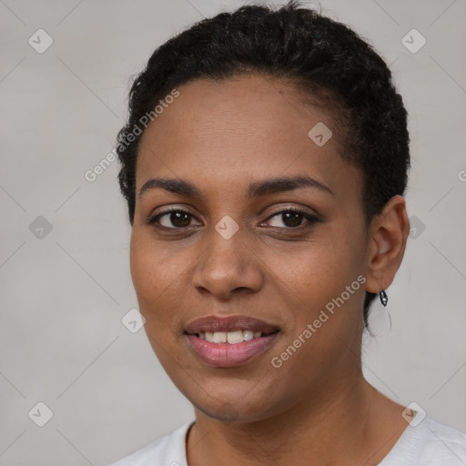 Joyful black young-adult female with short  brown hair and brown eyes