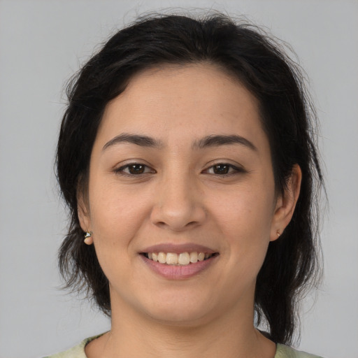 Joyful latino young-adult female with medium  brown hair and brown eyes