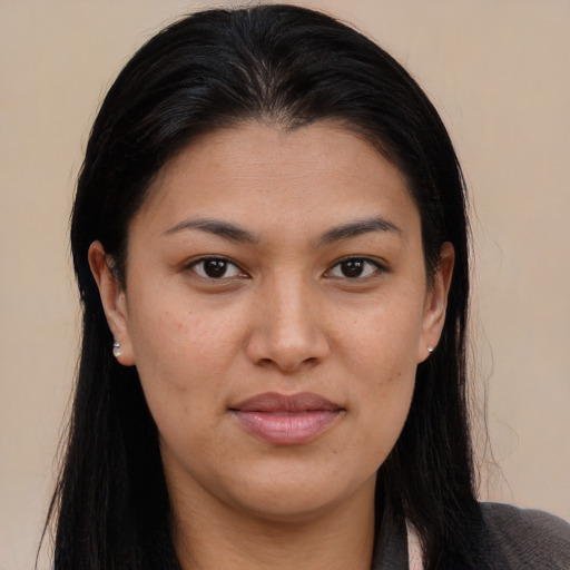 Joyful latino young-adult female with long  brown hair and brown eyes