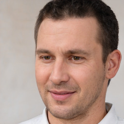 Joyful white adult male with short  brown hair and brown eyes