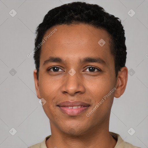 Joyful latino young-adult male with short  brown hair and brown eyes