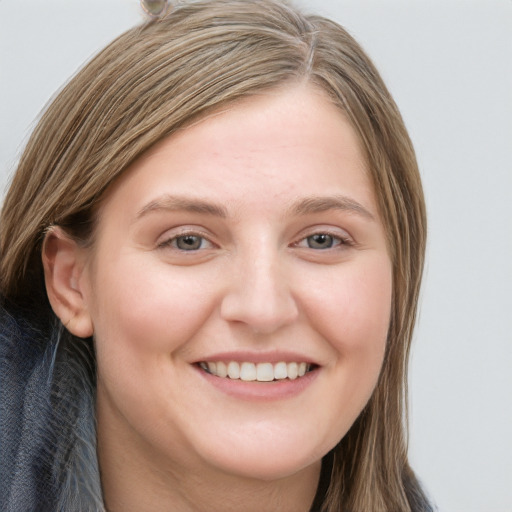 Joyful white young-adult female with long  brown hair and grey eyes