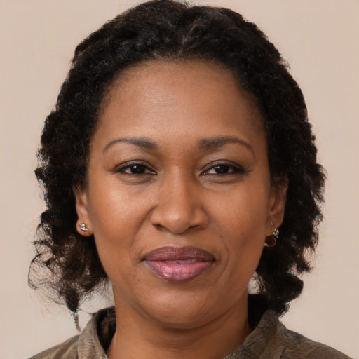 Joyful black adult female with medium  brown hair and brown eyes