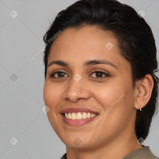 Joyful latino young-adult female with medium  brown hair and brown eyes