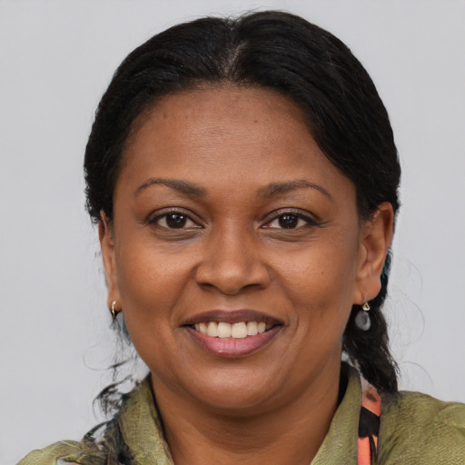 Joyful latino adult female with medium  brown hair and brown eyes