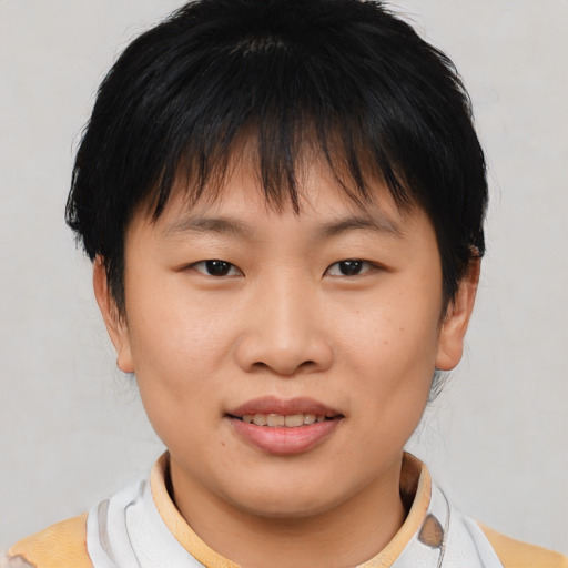 Joyful asian young-adult female with short  brown hair and brown eyes