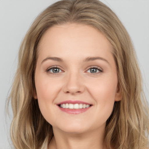 Joyful white young-adult female with long  brown hair and grey eyes