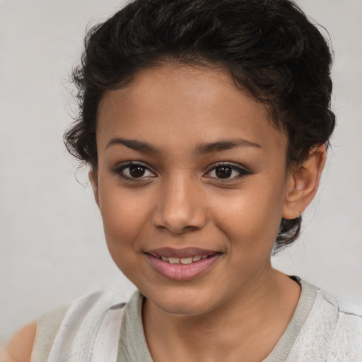 Joyful latino child female with short  brown hair and brown eyes