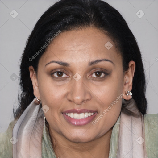 Joyful latino adult female with medium  brown hair and brown eyes