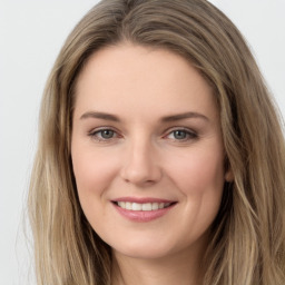 Joyful white young-adult female with long  brown hair and grey eyes