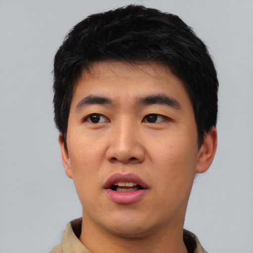 Joyful asian young-adult male with short  black hair and brown eyes