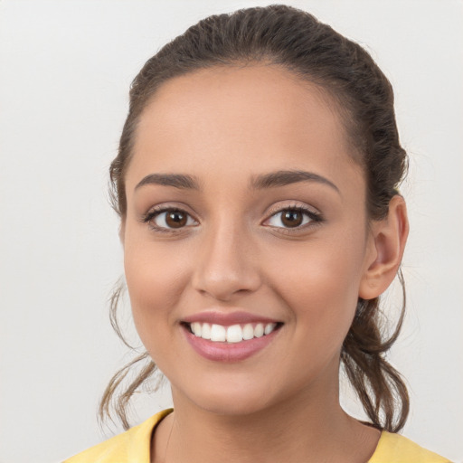 Joyful white young-adult female with medium  brown hair and brown eyes