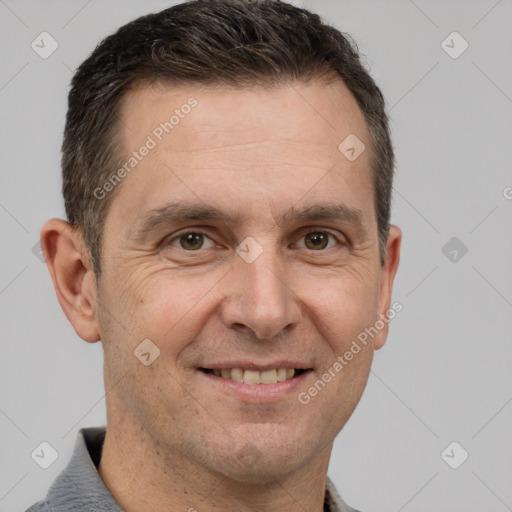 Joyful white adult male with short  brown hair and brown eyes