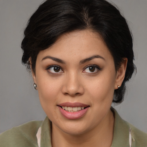 Joyful latino young-adult female with medium  brown hair and brown eyes