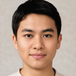 Joyful asian young-adult male with short  black hair and brown eyes