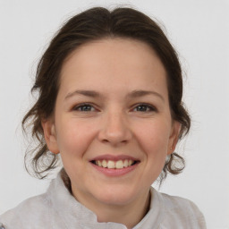 Joyful white young-adult female with medium  brown hair and brown eyes