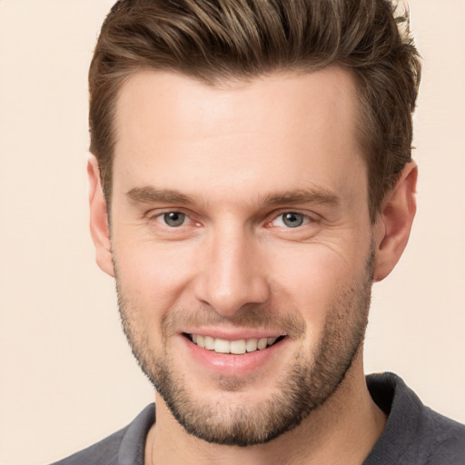 Joyful white young-adult male with short  brown hair and brown eyes